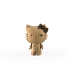 A wooden figurine resembling the fictional character Hello Kitty stands upright. Crafted from European FSC White Oak, it features carved detailing for the eyes, nose, and whiskers, along with a dark wooden bow on its left ear. This piece embodies Hello Kitty, Oak against a plain white background.