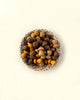 A bowl filled with Grapat Mandala Little Mushrooms from sustainable forests on a light-colored background, with the bowl displaying a geometric pattern.