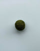 a forest green felt ball on a light blue background.