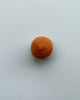 a burnt orange color felt ball on a light blue background.