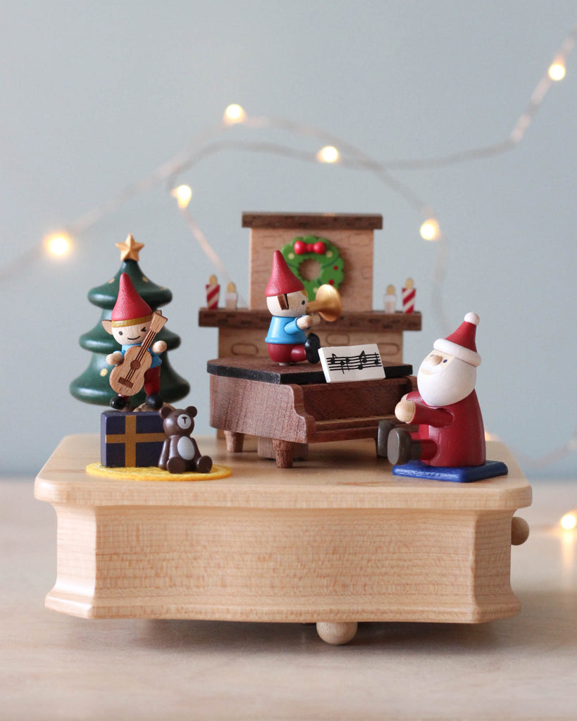 Christmas themed music box with Santa and elves playing music