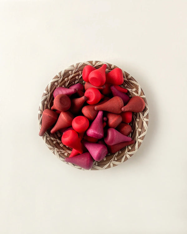 A wicker basket filled with Grapat Mandala Cones Fire, photographed from above on a light background using non-toxic dyes.