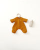 A mustard-colored baby onesie displayed alongside a baby bottle, all set against a plain white background, perfect for matching with Olli Ella Dinkum Doll Extra Clothing.