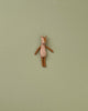 A small deer stuffed animal photographed on a flat background.