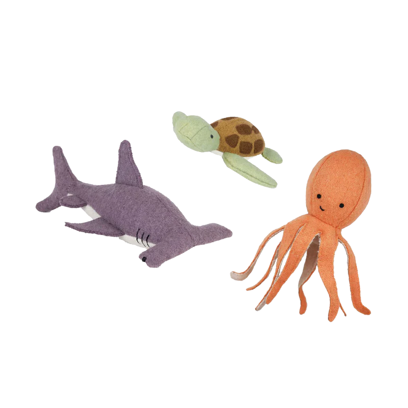 Olli Ella Holdie Folk Felt Marine Animals cutouts including a purple shark, green turtle, and orange octopus on a black background.