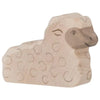 Wooden sheep figurine with light brown body and darker face, featuring simple carved details and a smiling expression. Made in Europe, this Holztiger Lying Lamb boasts small circular patterns resembling wool, showcasing the quality of handcrafted wood.