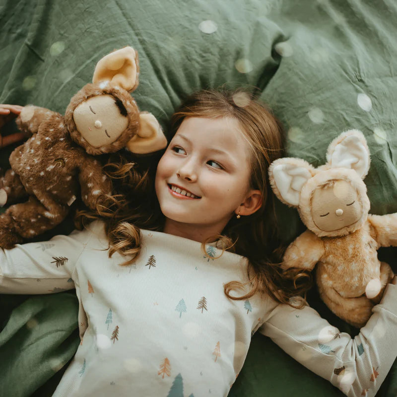 Two stuffed dolls in deer costumes photographed with a girl in the middle 