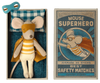 A Maileg | Superhero Mouse, Little Brother dressed as a superhero, lying in a colorful matchbox labeled "Little Brother Superhero" with comic book-style artwork, all suggesting a Danish design theme.