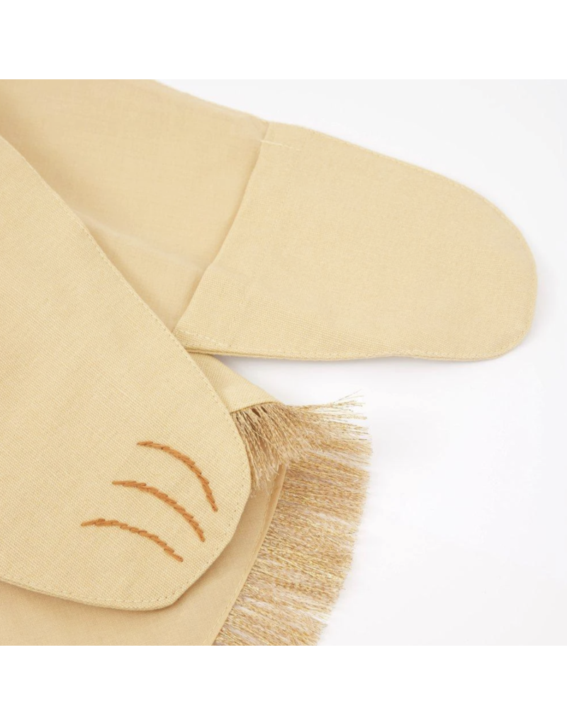 A close-up image of a pair of yellow ballet shoes with a fringed cloth, part of the Meri Meri Lion Costume - Final Sale, detailed with delicate brown stitching resembling three curved lines on the side.