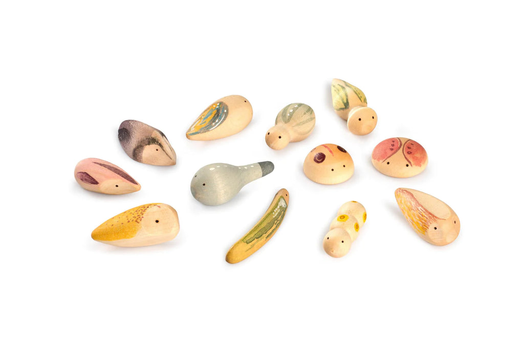 An assortment of colorful, hand-painted Grapat Wild Exploration Play Set shaped like creatures from the fauna realm, displayed on a white background. Each whistle features unique patterns and colors and ranges in dimensions from 1.